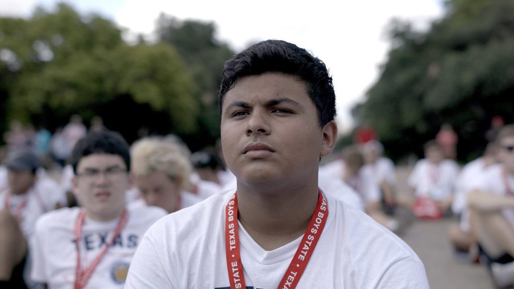 Teen boy at Texas Boys State event looking thoughtful