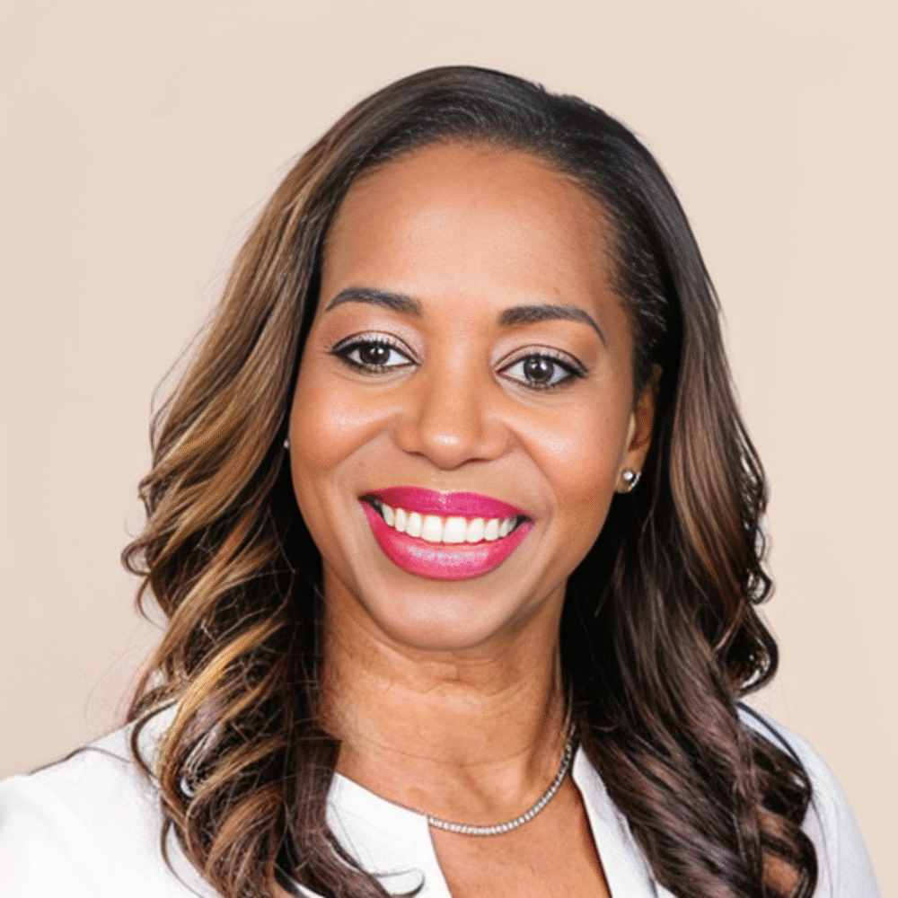 Shannon Nash, smiling woman with long brown hair and a white blazer.