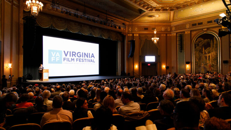 Virginia Film Festival event with speaker on stage and large audience.