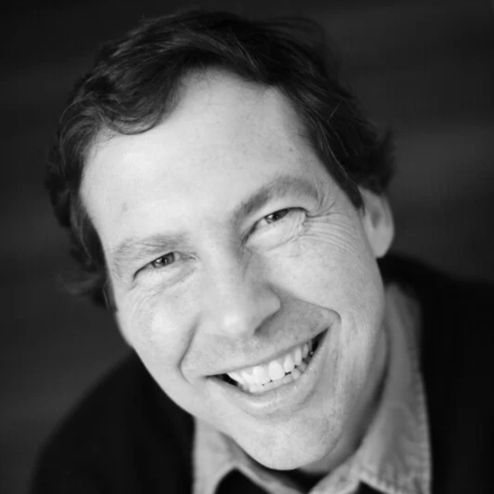 Close-up portrait of Chris Farina smiling broadly