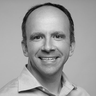 Colin Whitlow portrait, smiling with a friendly expression.