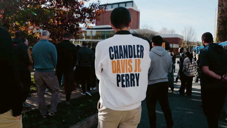 Virginia Cavaliers celebrate Super Bowl Champions trophy in triumph.