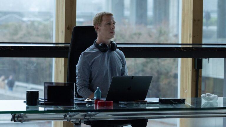 Todd Black, producer of 'Social Reckoning,' at his desk with laptop.