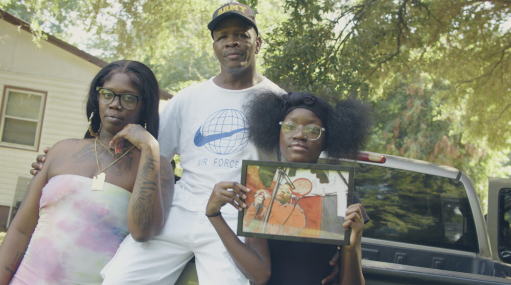 Family holding a photo in front of a truck, "9th & Gasoline" blog