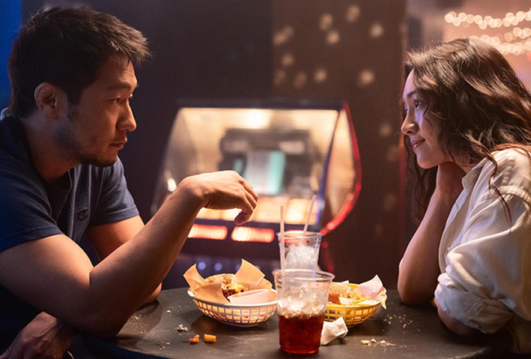 Couple eating burgers and fries at a diner in Bedford Park