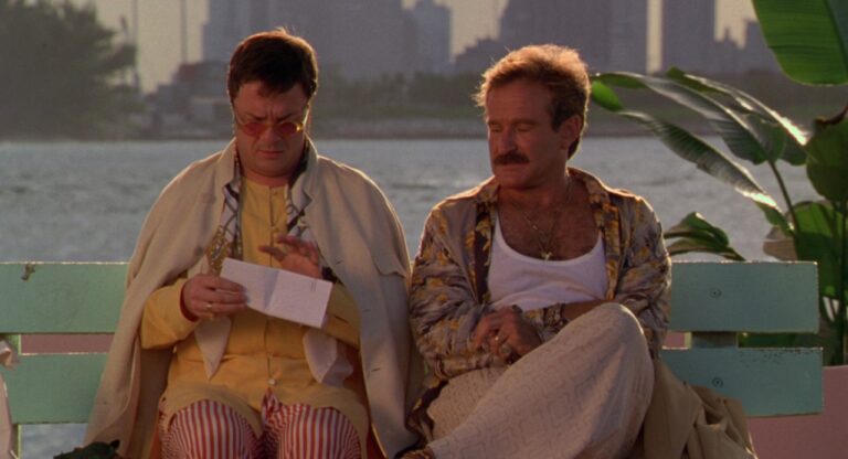 Armand and Albert in The Birdcage (30th Anniversary) sit on a bench.