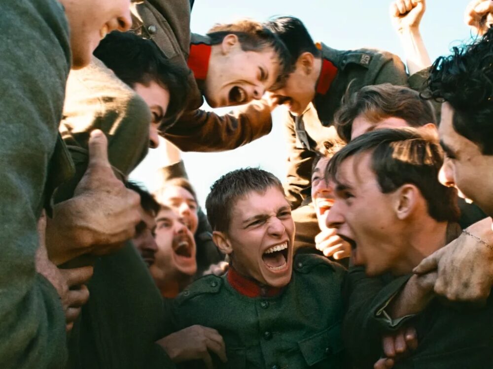 Soldiers in uniform celebrating in a moment of intense emotion, possibly after a battle.