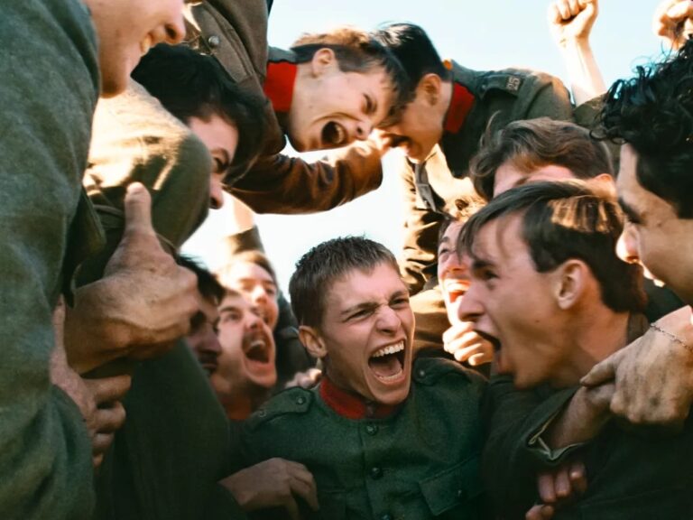 Soldiers in uniform celebrating in a moment of intense emotion, possibly after a battle.
