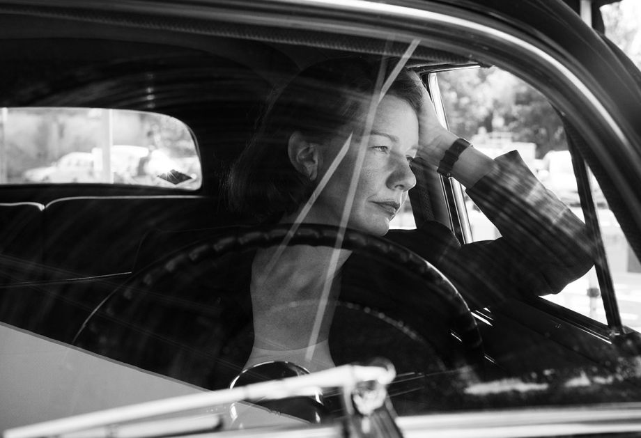 Woman in vintage car, reflecting on Fatherland