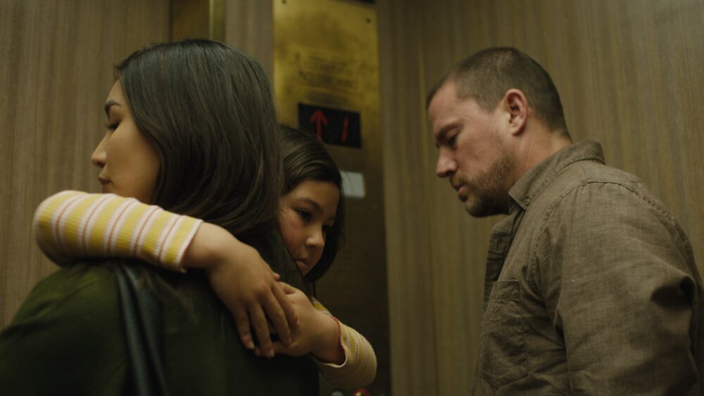Josephine's family in an elevator: mother, daughter, father.