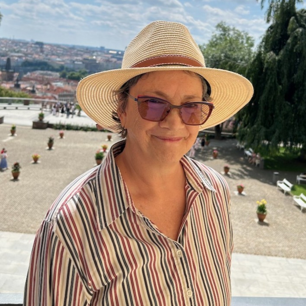 Anne Thompson wearing a hat and striped shirt in Prague