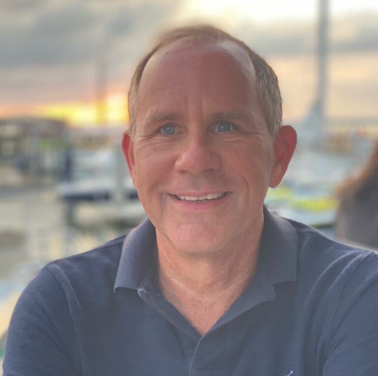 Portrait of Bill Short smiling outdoors at sunset
