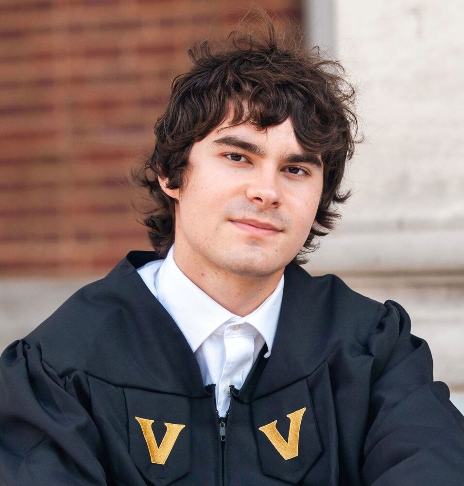Colin Vess in graduation regalia with gold V emblems.