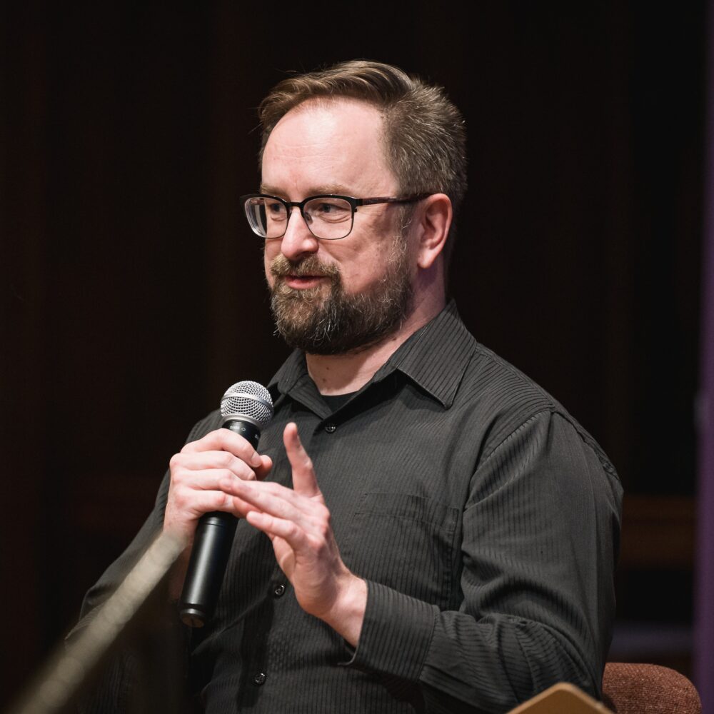 David McCormick speaking into a microphone at a podium.
