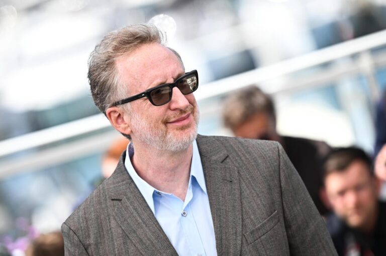 Man in suit and sunglasses at an outdoor event