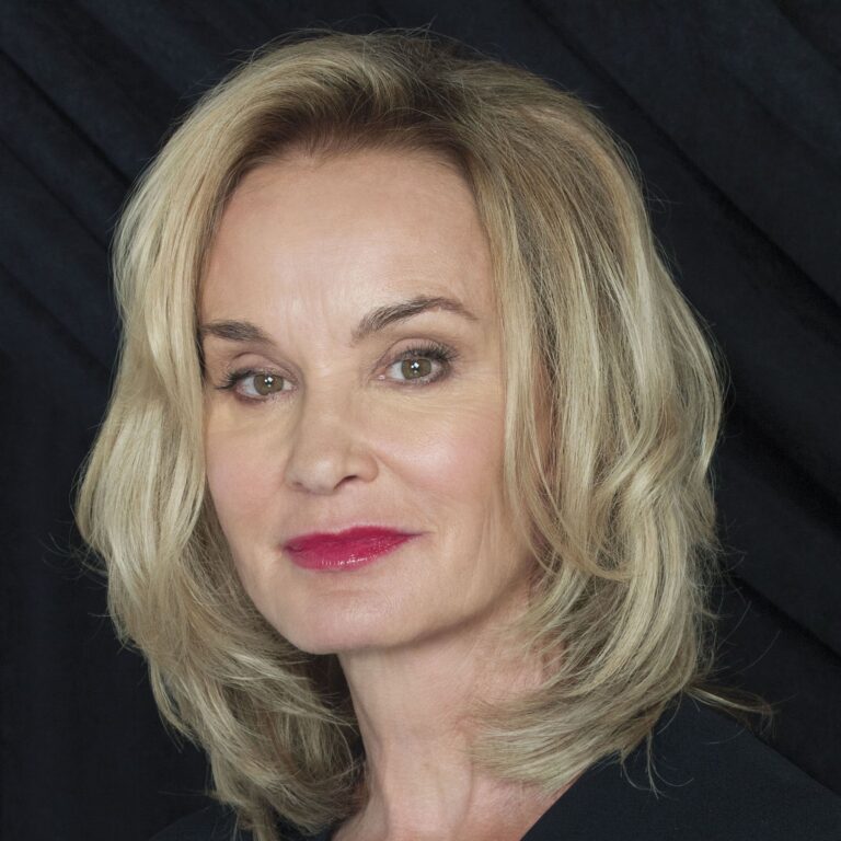 Jessica Lange in a black top against a black background