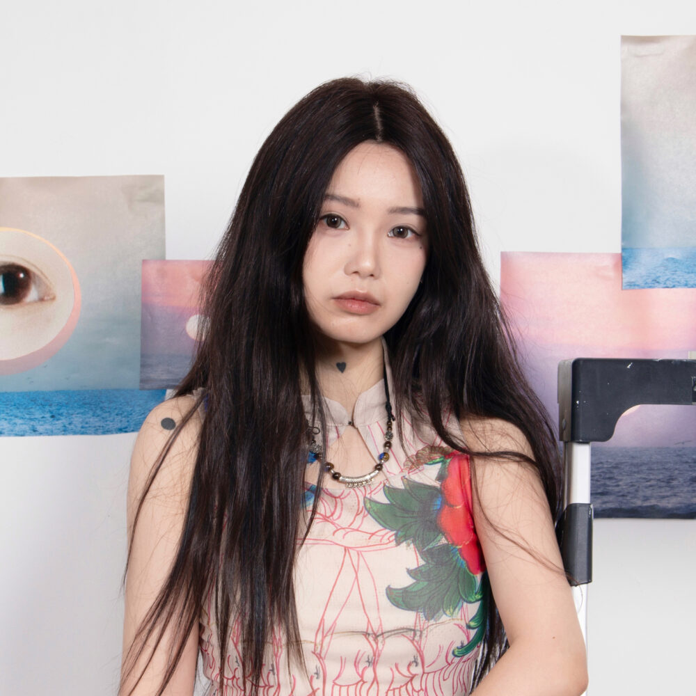 Jiayi Liang in a floral dress with a mosaic background