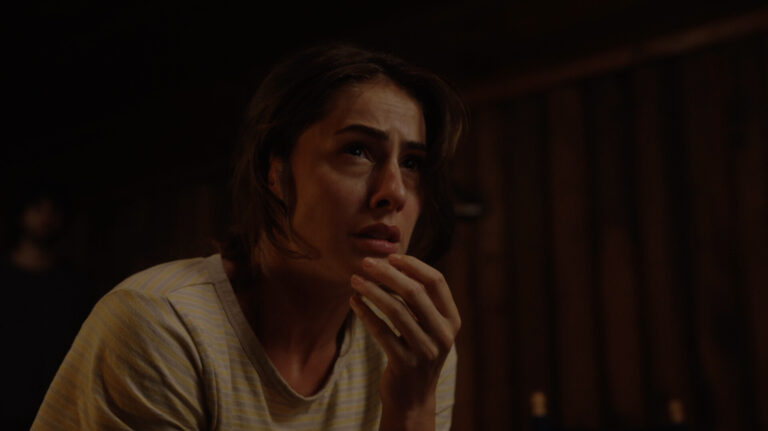 Woman with worried expression in dim light