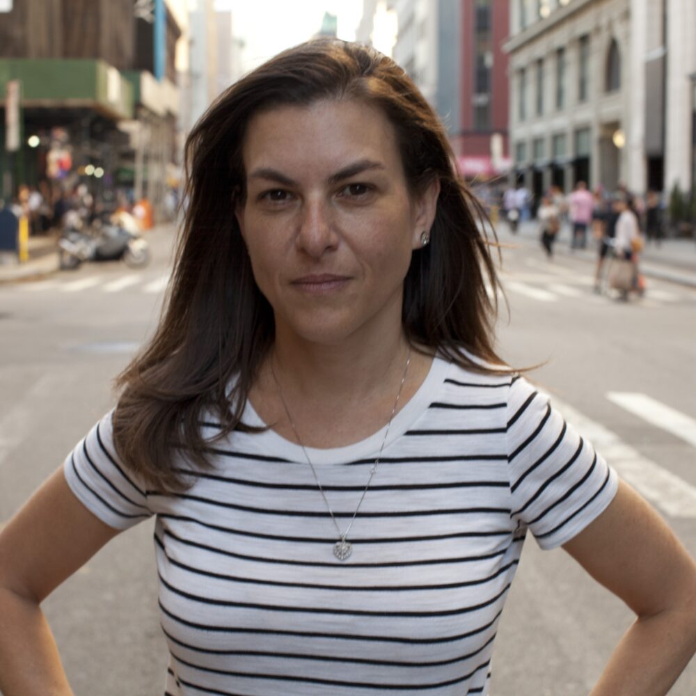 Nanette Burstein in a striped shirt on a city street