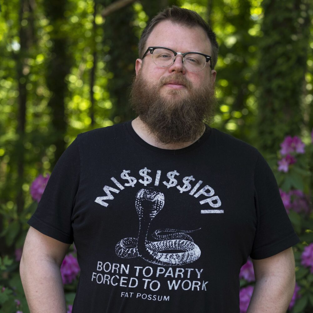 Pat Jarrett wearing a black "Mississippi Born to Party Forced to Work" t-shirt.