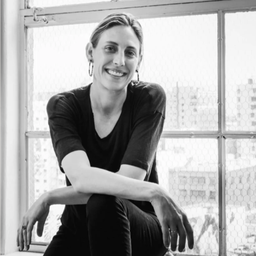 Portrait of Ruth De Jong smiling by a window