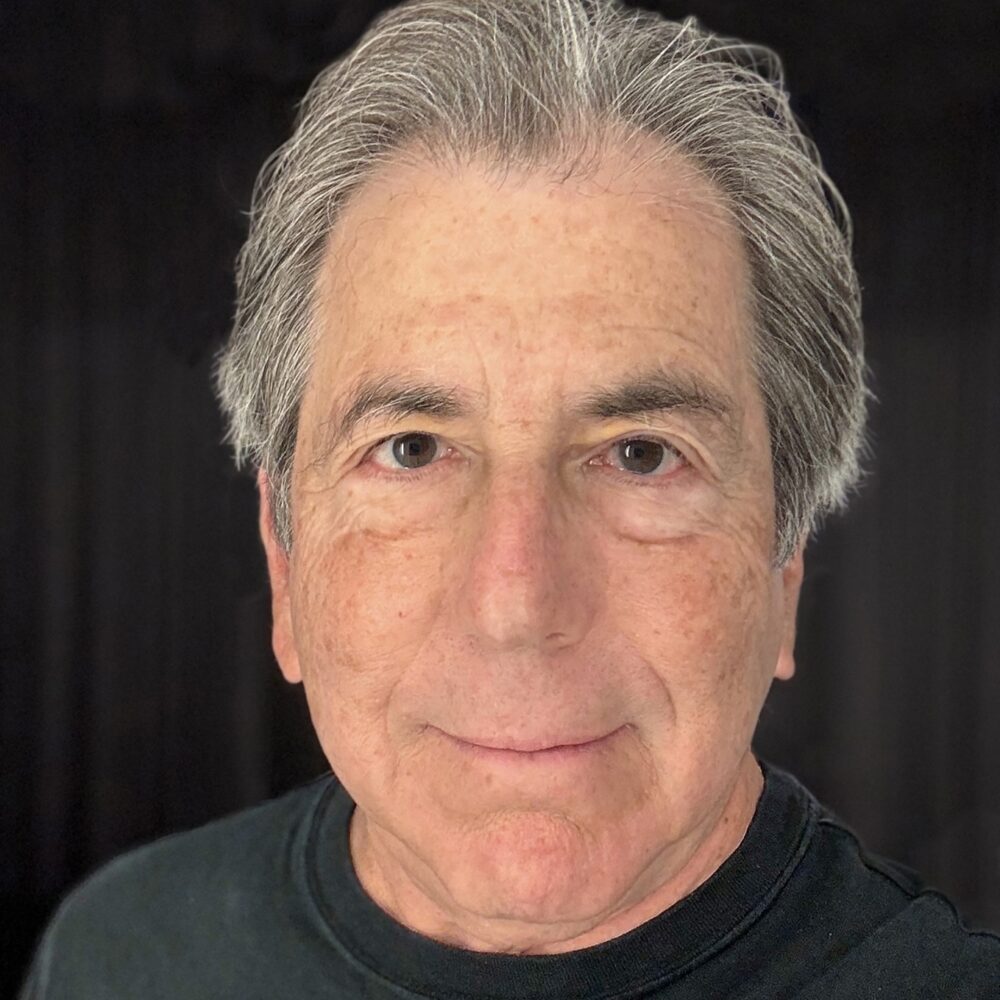 Steven Pressman, a man with graying hair, smiles at the camera.