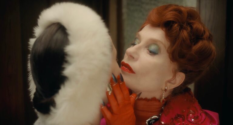The Blood Countess: Woman with striking makeup and red gloves leans in.