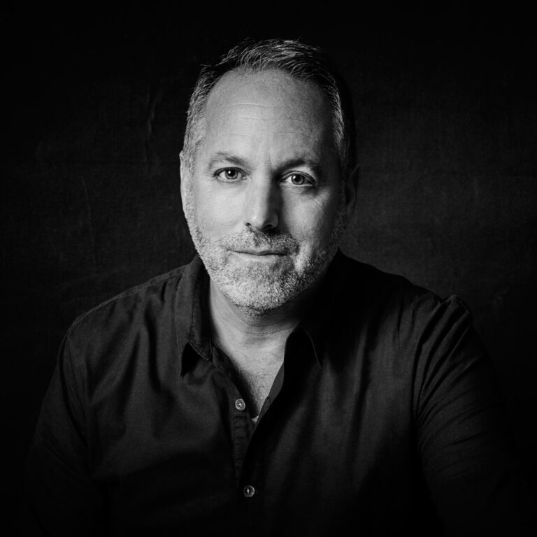 Black and white portrait of Todd Black, a man with graying hair and beard.
