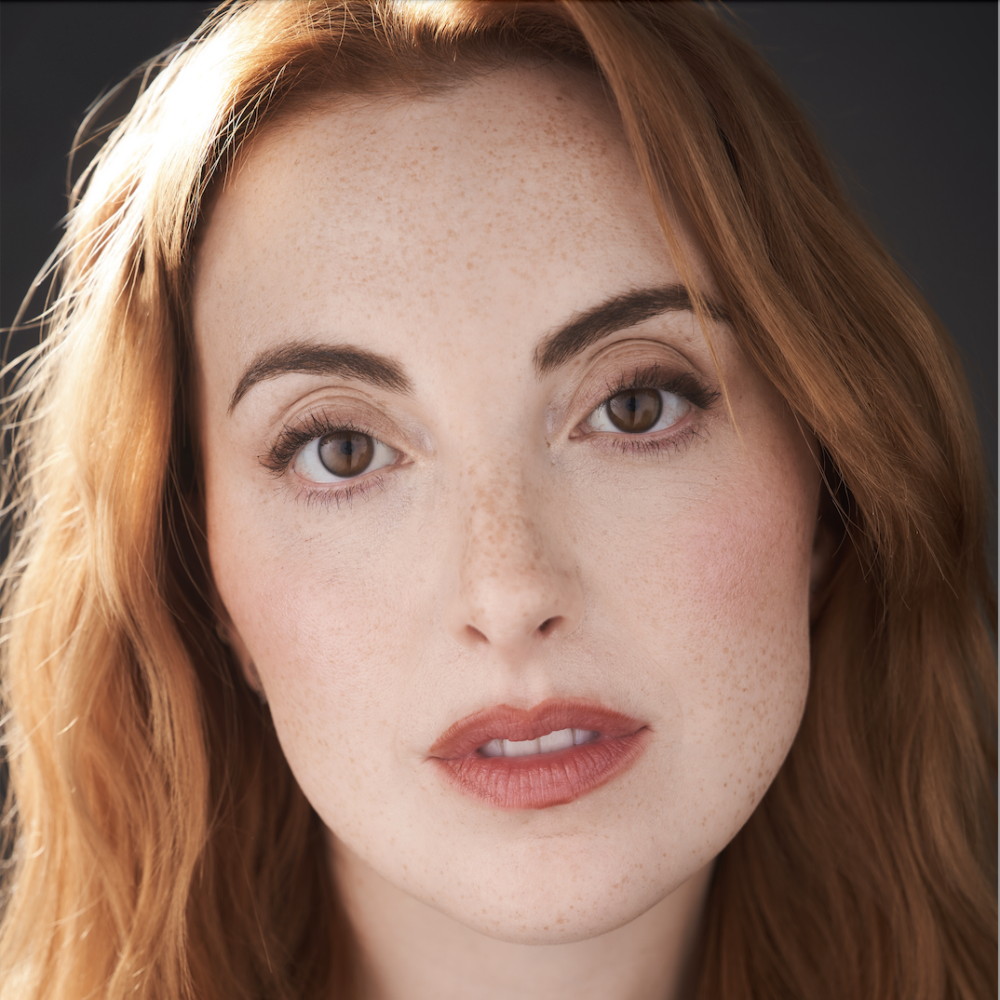 Close-up portrait of Juliette Goglia with red hair and freckles