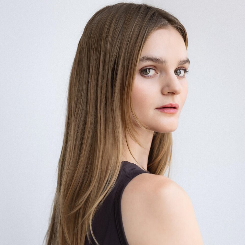 Kerris Dorsey looking over her shoulder with long, blonde hair.