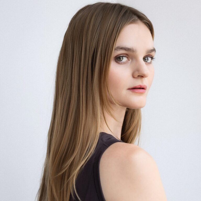 Kerris Dorsey looking over her shoulder with long, blonde hair.